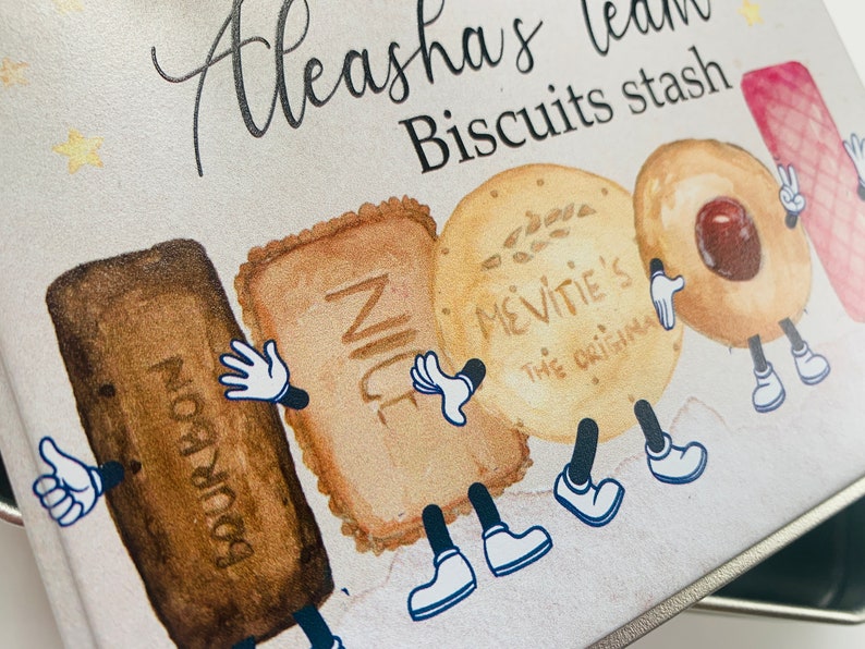 May include: A white metal tin with a cartoon illustration of biscuits with legs and arms. The tin is labelled "Aleeasha's tea Biscuits stash". The biscuits are labelled "Bourbon", "Nice", "McVitie's The Original", and a round biscuit with a red centre.