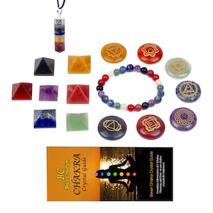 May include: A collection of chakra healing crystals and accessories. Includes a pendant, pyramids, a beaded bracelet, and engraved stones. A guide titled "Chakra Crystal Guide" is also present, with the text "BC Bliss Creation".