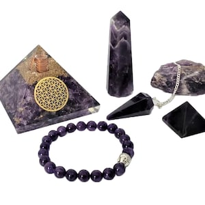 May include: A set of amethyst crystals, including a pyramid, a point, a pendulum, a small pyramid, and a bracelet. The pyramid has a gold flower of life symbol on it.