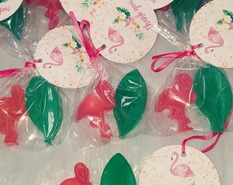May include: Pink flamingo shaped soap favours with green leaf soap favours in clear cellophane bags tied with pink ribbon and a round white tag with pink flamingo and floral design that says "Thank you so much!"