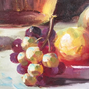 May include: A still life painting of a bunch of grapes, a yellow and red fruit, and a brown bowl. The grapes are purple and green, and the fruit is partially visible. The painting is done in a realistic style.