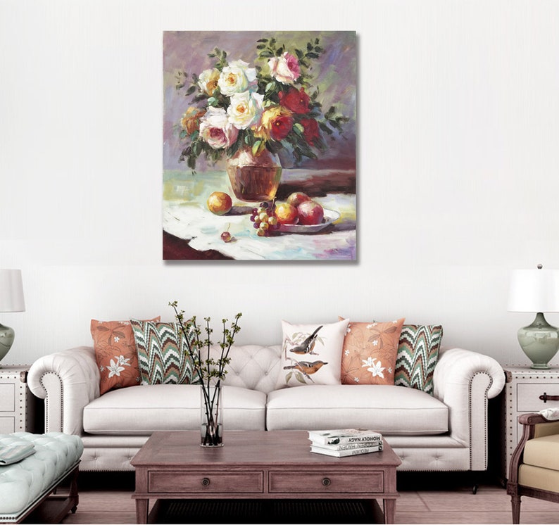 May include: A still life painting of a bouquet of white and red roses in a brown vase, with grapes and apples on a white tablecloth.