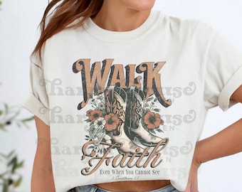 May include: A white t-shirt with a vintage-style graphic design featuring a pair of cowboy boots and the text "Walk by Faith Even When You Cannot See 2 Corinthians 5:7".