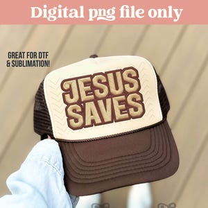 May include: A brown and beige trucker hat with the text "JESUS SAVES" in a bold, outlined font. The hat has a mesh back and a curved brim. The image also includes the text "Digital png file only" and "GREAT FOR DTF & SUBLIMATION!"