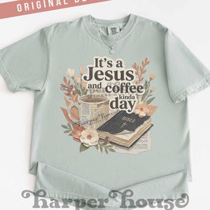 May include: A light green t-shirt with the text "It's a Jesus and coffee kinda day" and floral graphics. The design includes a coffee cup, a Bible, and decorative flowers. The shirt also has the text "harper house THREE SIXTEEN".