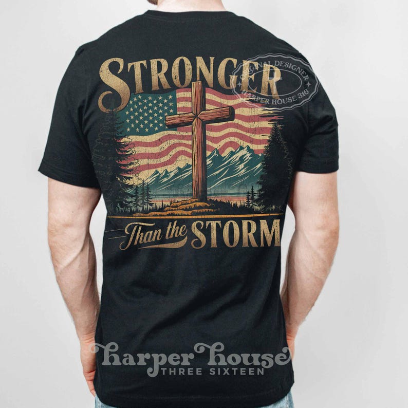 May include: A black t-shirt with a vintage-style graphic of a cross in front of an American flag. The text "Stronger Than the Storm" is printed below the graphic. The shirt has a distressed look and is perfect for anyone who wants to show their faith and patriotism.
