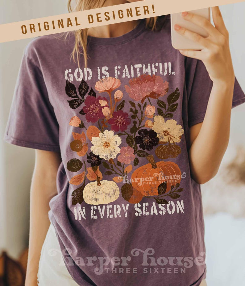 May include: Purple t-shirt with a floral design and the text "GOD IS FAITHFUL IN EVERY SEASON." The design includes flowers and pumpkins in shades of pink, orange, and white. The shirt also has the text "ORIGINAL DESIGNER!" and "Harper House THREE SIXTEEN."