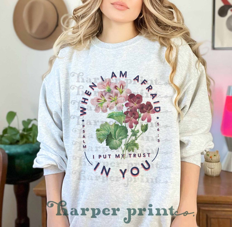 May include: A gray sweatshirt with a floral design and the text "When I am afraid I put my trust in you" and "Psalm 56:3".