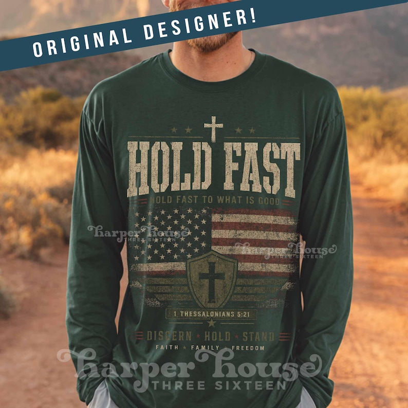 May include: Dark green long-sleeve shirt with a distressed American flag graphic and the words "HOLD FAST." The shirt also features a cross and the text "1 Thessalonians 5:21." The shirt is from Harper House Three Sixteen.