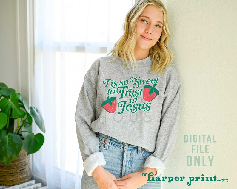 May include: A gray sweatshirt with a strawberry graphic and the text "Tis so Sweet to Trust in Jesus".