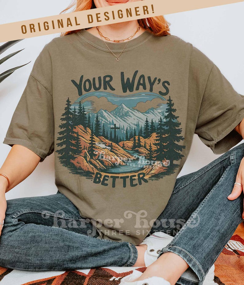 May include: Olive green t-shirt with a mountain and forest graphic. The graphic includes the text "Your Way's Better" in a stylized font. The shirt is a relaxed fit and has short sleeves.