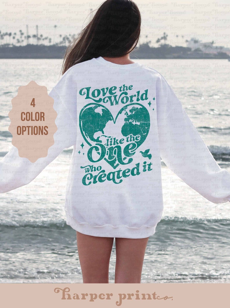 May include: White sweatshirt with a teal green heart design that says "Love the World like the One who Created it".