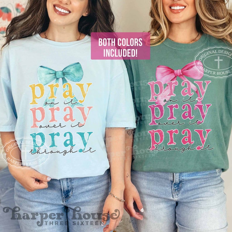 May include: Two t-shirts with a watercolor bow and the text "pray on it pray over it pray through it". The shirts are light blue and green.