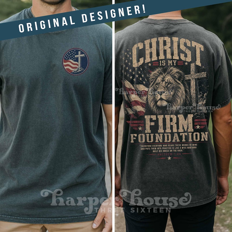 May include: Dark gray t-shirt with a distressed look. The front features a circular design with a cross, American flag, and text. The back displays a lion, cross, flag, and the words "Christ is my Firm Foundation."