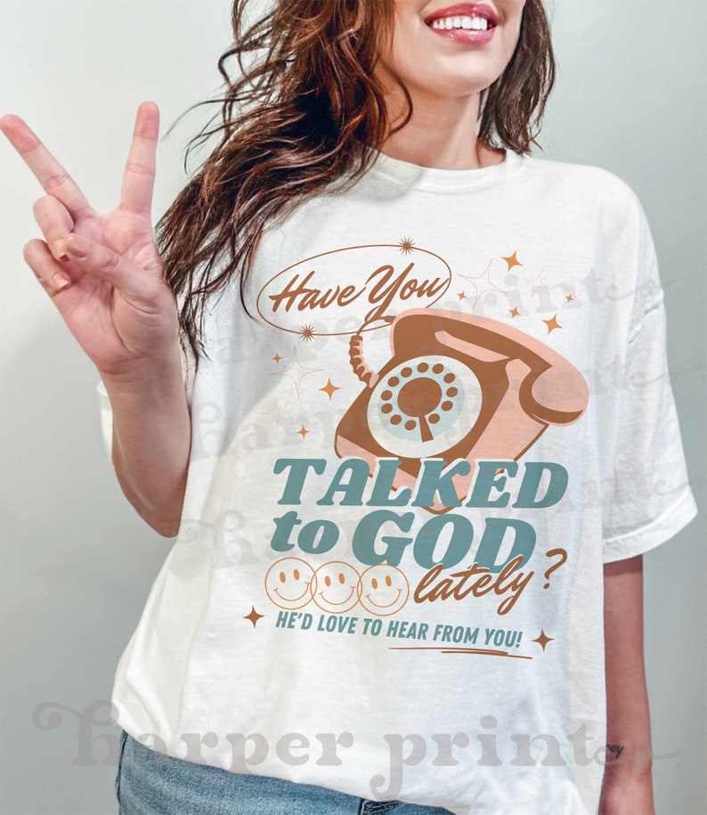 May include: A white t-shirt with a graphic of a vintage rotary phone with the text "Have You Talked to God Lately?" and "He'd Love to Hear From You!"
