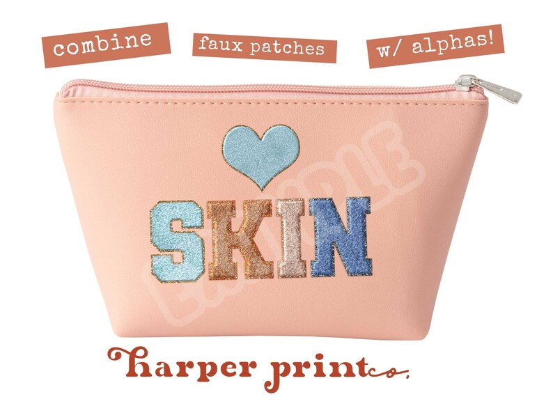 May include: Pink cosmetic bag with a heart and the word "SKIN" in colorful embroidered letters. The bag has a zipper closure and a small silver pull tab. The text "harper print co." is printed in brown below the bag.