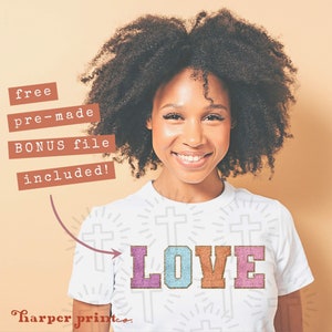 May include: A white t-shirt with a colorful "LOVE" graphic. The graphic is made of pink, blue, and orange letters with a glittery texture. The shirt has a pattern of small crosses on it. The text "free pre-made BONUS file included!" is written in brown text on a white background.