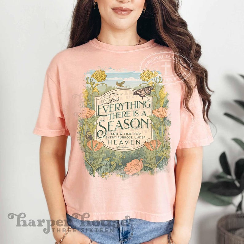 May include: A pink cropped t-shirt with a floral design and the text "For Everything There Is A Season And A Time For Every Purpose Under Heaven" in a green banner.