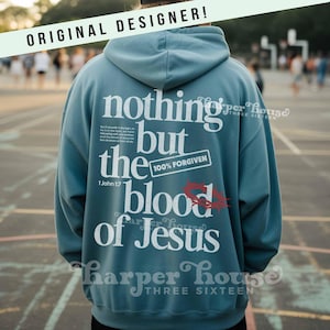 May include: A teal hoodie with the text "nothing but the blood of Jesus" in white. The phrase "100% FORGIVEN" is also visible. The hoodie has a hood and long sleeves. The words "ORIGINAL DESIGNER!" are at the top.