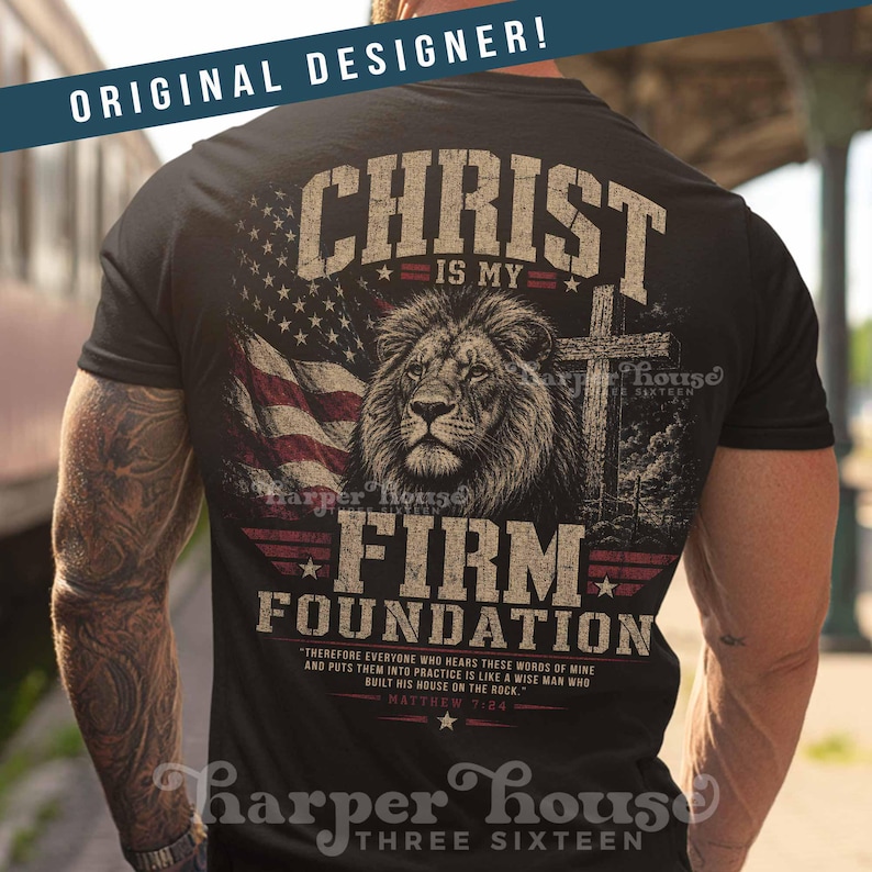 May include: Black t-shirt featuring a lion's head, American flag, and cross graphic. Text includes "CHRIST IS MY FIRM FOUNDATION" and a Bible verse. The shirt is from Harper House Three Sixteen.