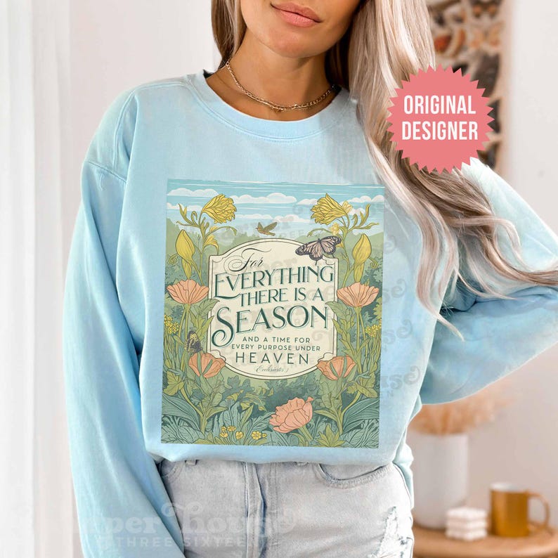May include: Light blue sweatshirt with a floral design and the text "For everything there is a season and a time for every purpose under heaven - Ecclesiastes 3".