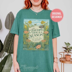 May include: A teal green t-shirt with a floral design and the text "For everything there is a season and a time for every purpose under heaven."  The text is in a white box with a black border.