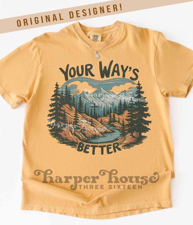 May include: Mustard yellow t-shirt with a mountain and river graphic. The graphic includes the text "Your Way's Better" and "Harper House Three Sixteen". The shirt has short sleeves and a crew neck.