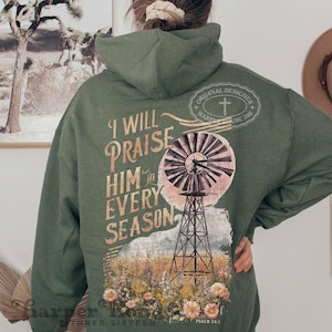 May include: Green hooded sweatshirt with a vintage-style graphic of a windmill and the text "I will praise him in every season" and "Psalm 34:1".