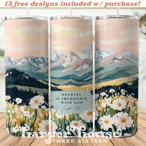 May include: A white tumbler with a mountain landscape and a field of daisies. The tumbler has a quote that reads "Nothing is impossible with God Luke 1:37".