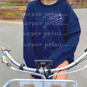 May include: A navy blue sweatshirt with a pink phone graphic and the text "Can't wait to hear from you! xo God".