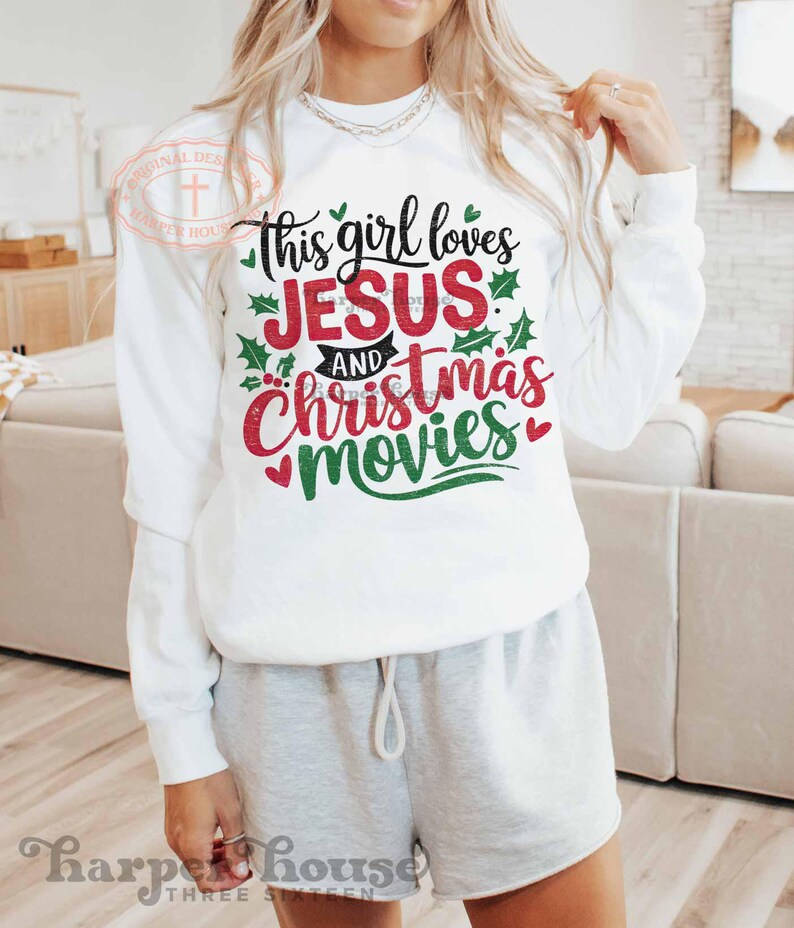 May include: White sweatshirt with the text "This girl loves Jesus and Christmas movies" in red and green lettering with holly leaves.