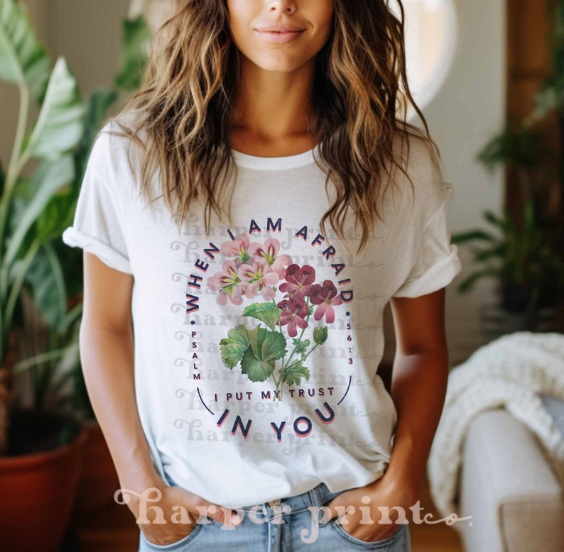 May include: White t-shirt with a floral design and the text "WHEN I AM AFRAID I PUT MY TRUST IN YOU" and "PSALM 56:3".