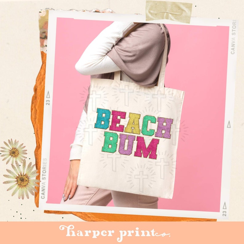 May include: A white canvas tote bag with the words "Beach Bum" in colorful, glittery letters. The bag has a white cross pattern on it.