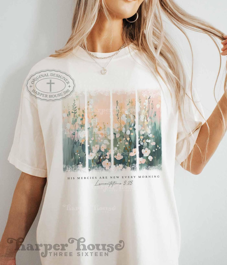 May include: A white t-shirt with a floral design and the text "His mercies are new every morning, Lamentations 3:23".