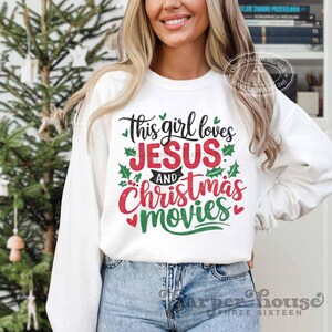 May include: White sweatshirt with a red and green graphic that says "This girl loves Jesus and Christmas movies".