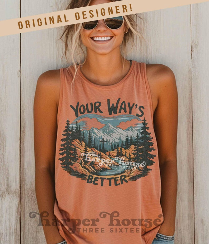 May include: A coral-colored tank top with a graphic design featuring a mountain landscape, trees, and the text "Your Way's Better." The tank top has a scoop neck and is sleeveless. The brand name "Harper House Three Sixteen" is printed at the bottom.