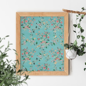May include: A framed print with a repeating pattern of pink and red flowers on a teal background. The flowers are arranged in bouquets and tied with pink ribbons.