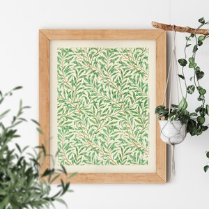 May include: A framed print of a vintage botanical illustration featuring a repeating pattern of green leaves and branches on a cream background.