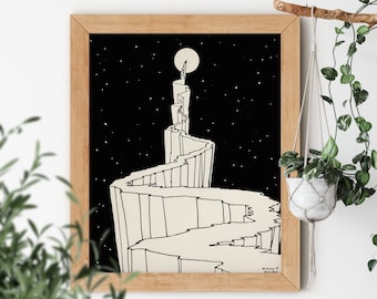 May include: Black and white line art print of a winding path leading up a mountain to a full moon. The print is framed in a light wood frame.