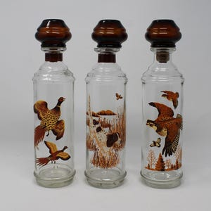 Choice of Cabin Still Collection, Kentucky Bourbon Decanters, Sold Separately.