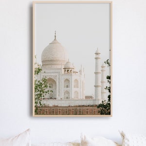 May include: A framed photograph of the Taj Mahal, a white marble mausoleum in Agra, India. The photograph is taken from a distance, showing the entire building and its surrounding gardens.
