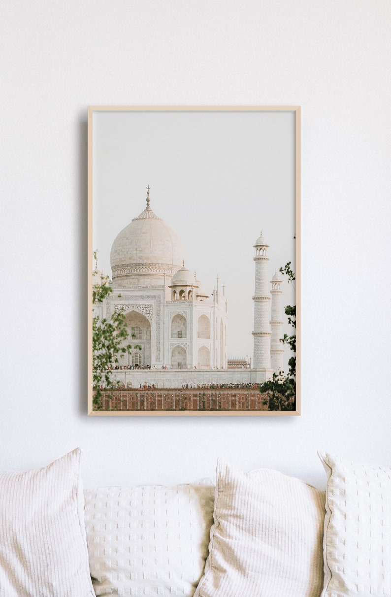 May include: A framed photograph of the Taj Mahal, a white marble mausoleum in Agra, India. The photograph is taken from a distance, showing the entire building and its surrounding gardens.