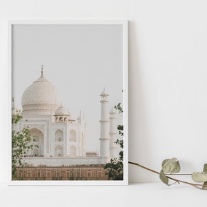 May include: A framed photograph of the Taj Mahal, a white marble mausoleum in Agra, India. The image is taken from a distance, showing the main dome and minarets of the building.
