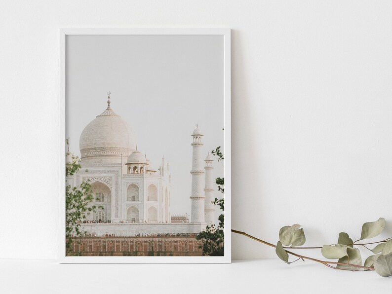 May include: A framed photograph of the Taj Mahal, a white marble mausoleum in Agra, India. The image is taken from a distance, showing the main dome and minarets of the building.