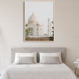 May include: A framed photograph of the Taj Mahal, a white marble mausoleum in Agra, India. The image is taken from a distance, showing the entire structure, including the central dome and minarets.