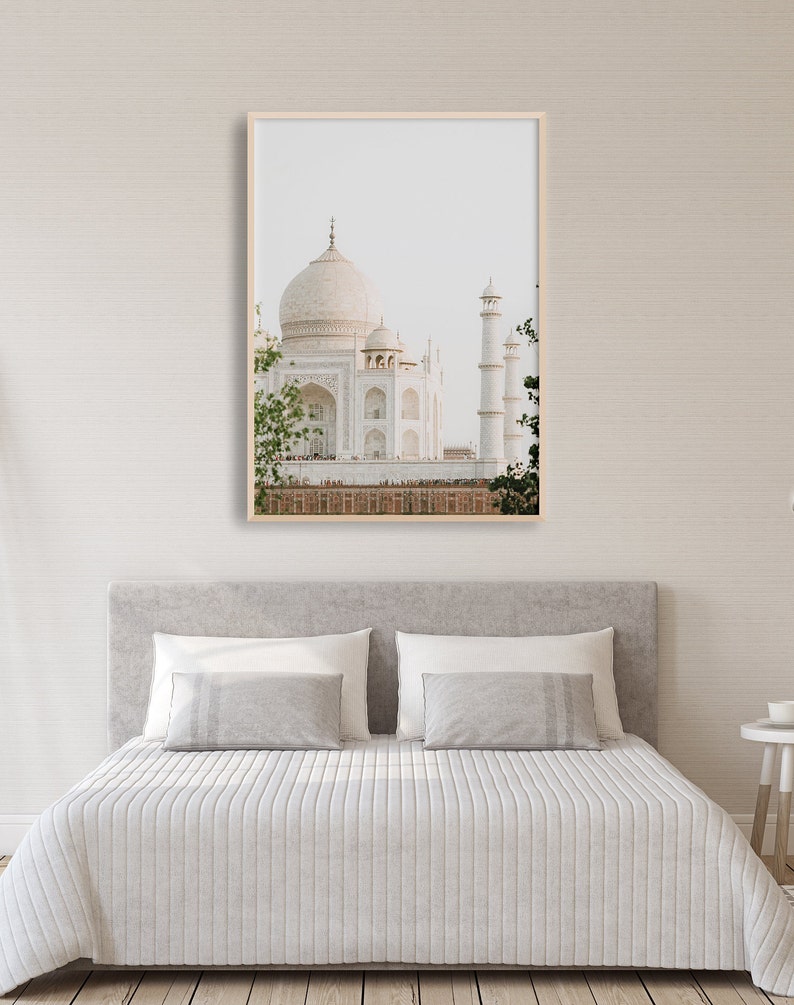 May include: A framed photograph of the Taj Mahal, a white marble mausoleum in Agra, India. The image is taken from a distance, showing the entire structure, including the central dome and minarets.