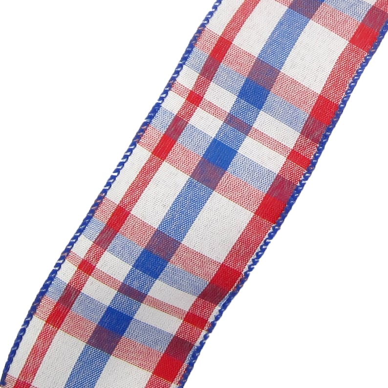 May include: Red, white and blue plaid ribbon with a white background. The ribbon has a woven texture and is edged with white stitching.