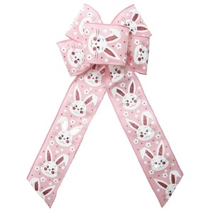 May include: A pink ribbon with a white bunny rabbit pattern. The ribbon is tied into a bow and is perfect for decorating for Easter.
