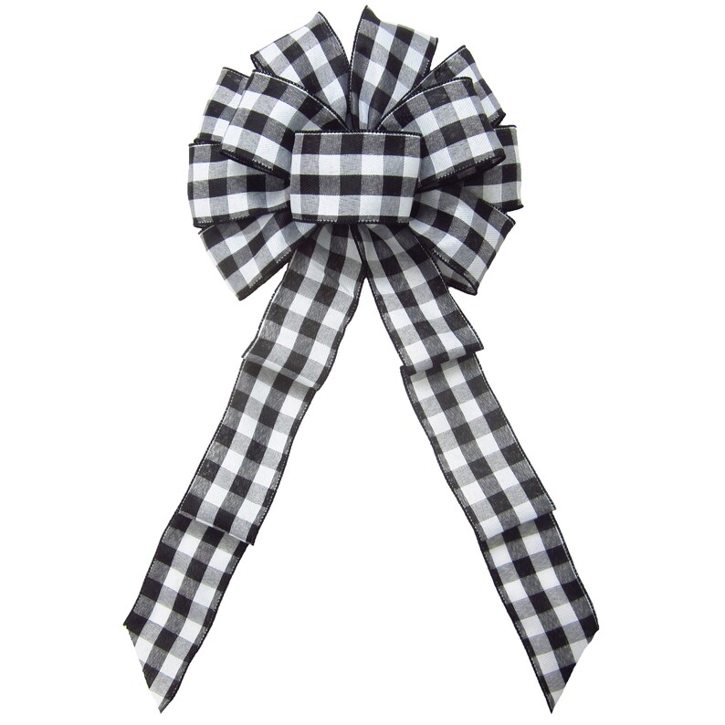 May include: A black and white checkered bow with long tails. The bow is tied in a classic style with the tails hanging down.