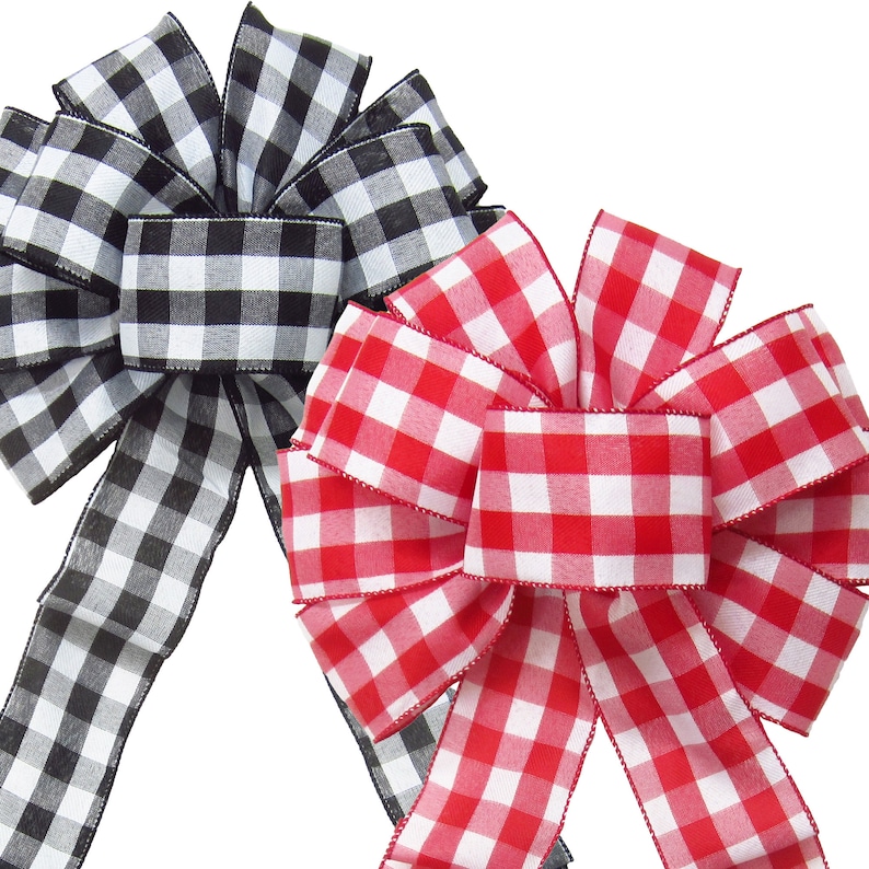 May include: Two gingham bows, one black and white and one red and white. The bows are tied with a loop and tails.